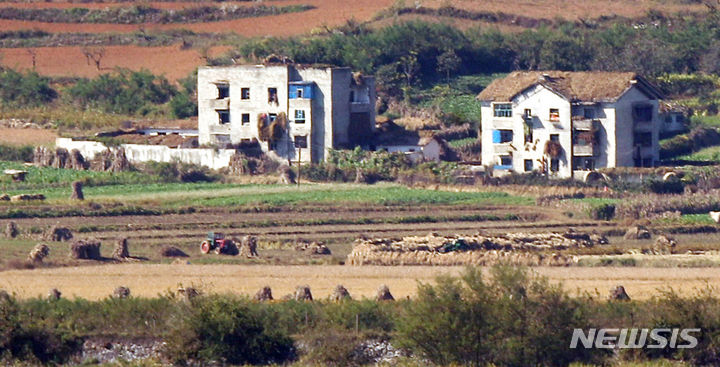 북한 노동당 창건 78주년을 맞은 지난해 10월10일 경기 파주시 오두산 통일전망대에서 바라본 북한 황해북도 개풍군 마을에서 북한 주민이 가을 걷이를 하고 있다. [ 사진 = 뉴시스 ]